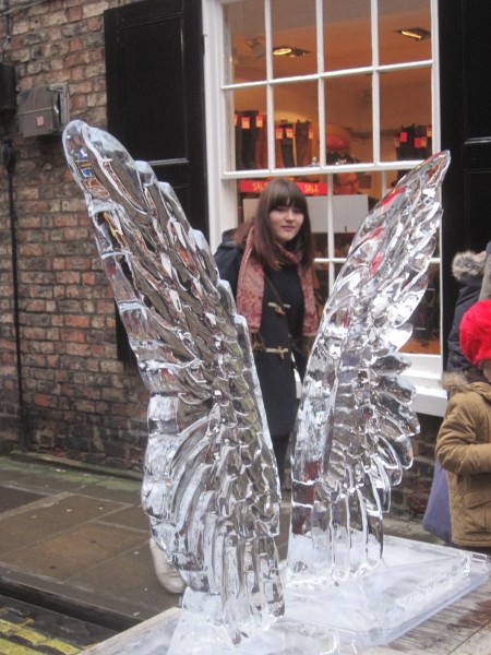 An innocent bystander peeps through the angel wings