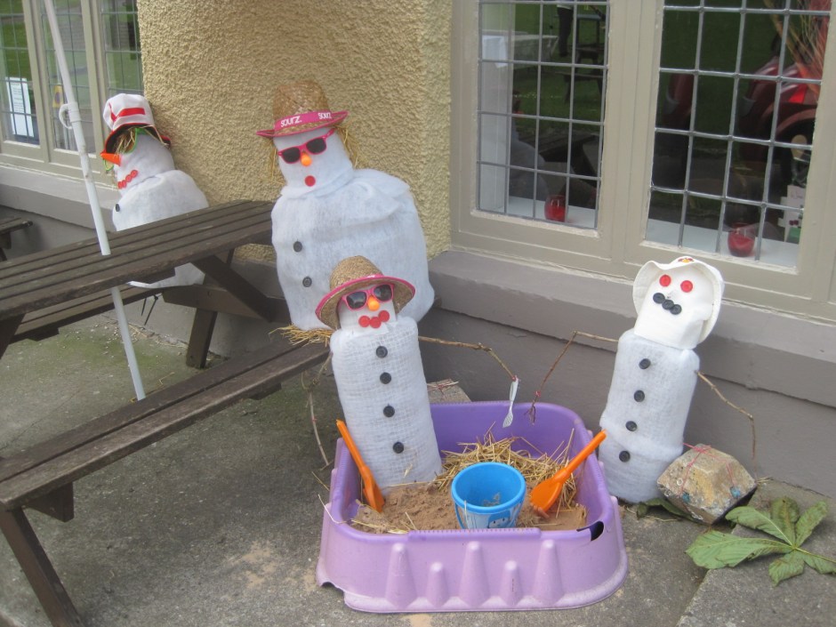 Snowmen at the beach- that's definitely madness!