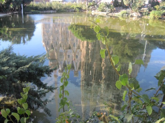 Sagrada Familia, reflected in the lake in Gaudi Square