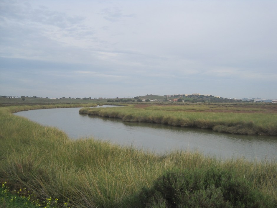 In the distance, across the river, the hilltop fortress of Castro Marim