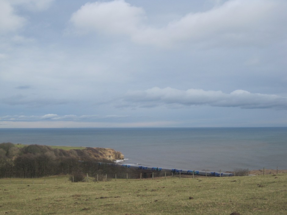 Notice the goods train in the foreground