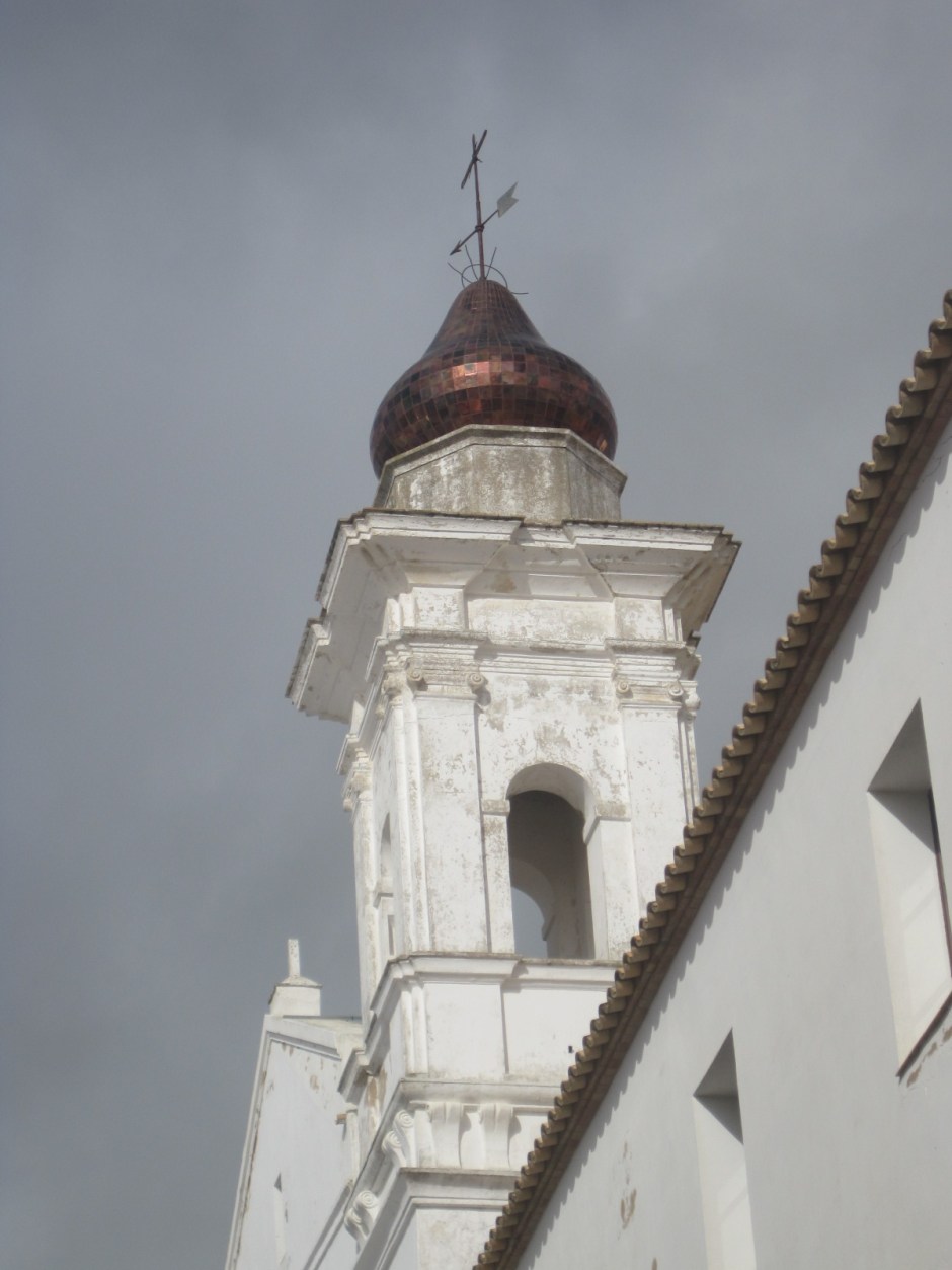The bronze dome pierces the clouds