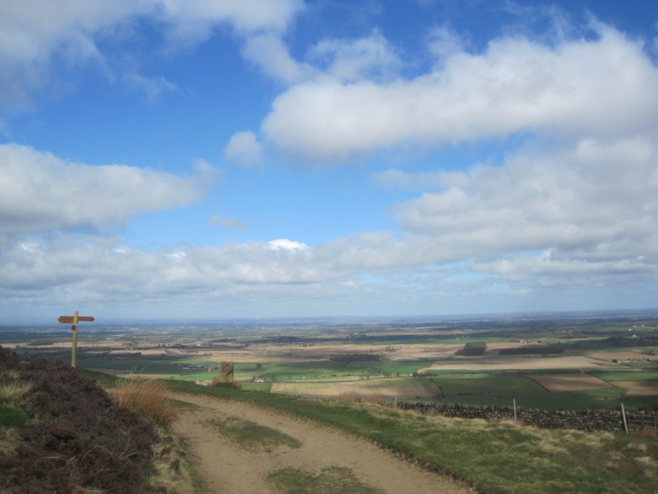 The countryside drops away below us