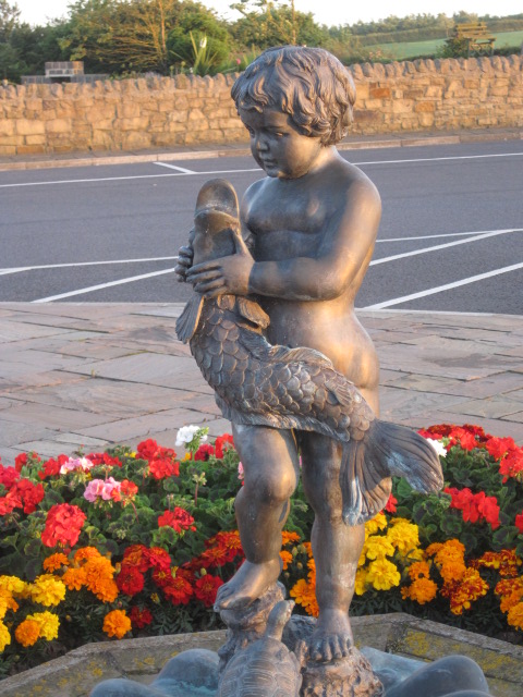 The sun's last rays were just gilding this statue, at the Golf Club