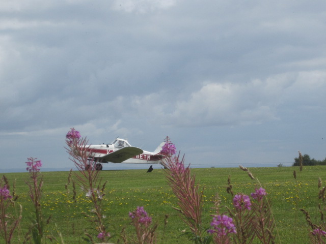 The plane whizzes past, towing the glider