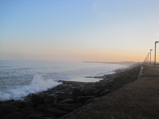 Can you see the fishermen, huddled against the rocks?