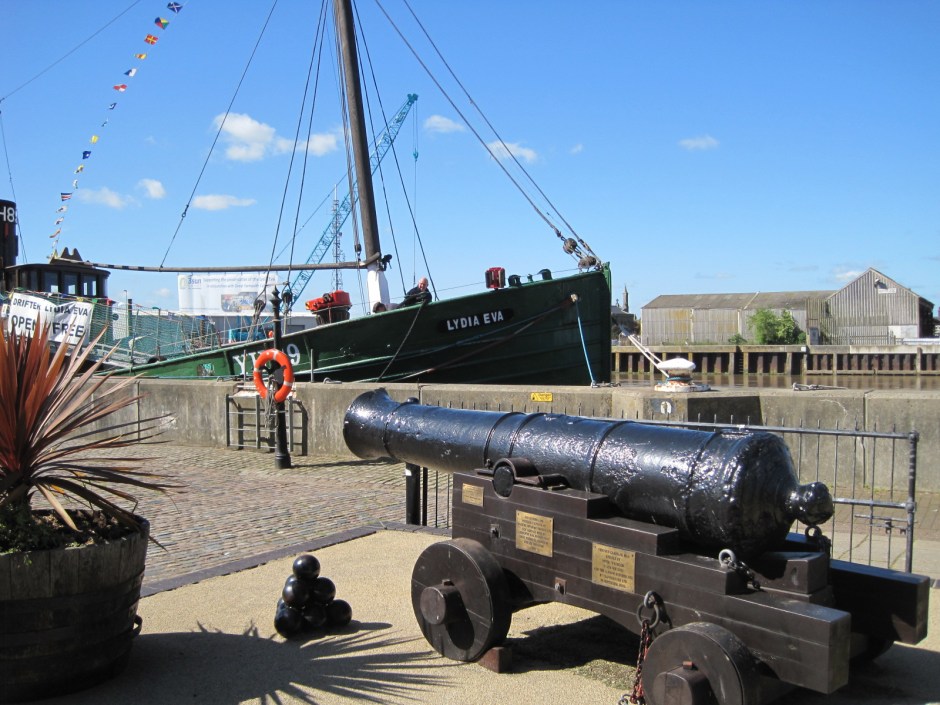 A canon from the Napoleonic Wars alongside an elderly fishing smack 