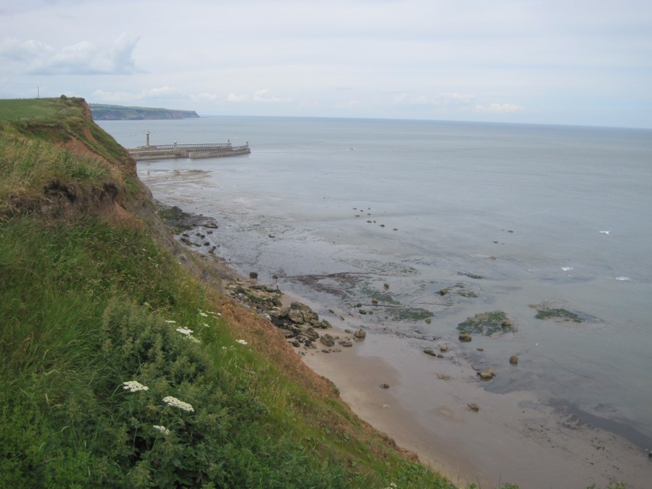 As we approach the outstretched arms of the pier at Whitby